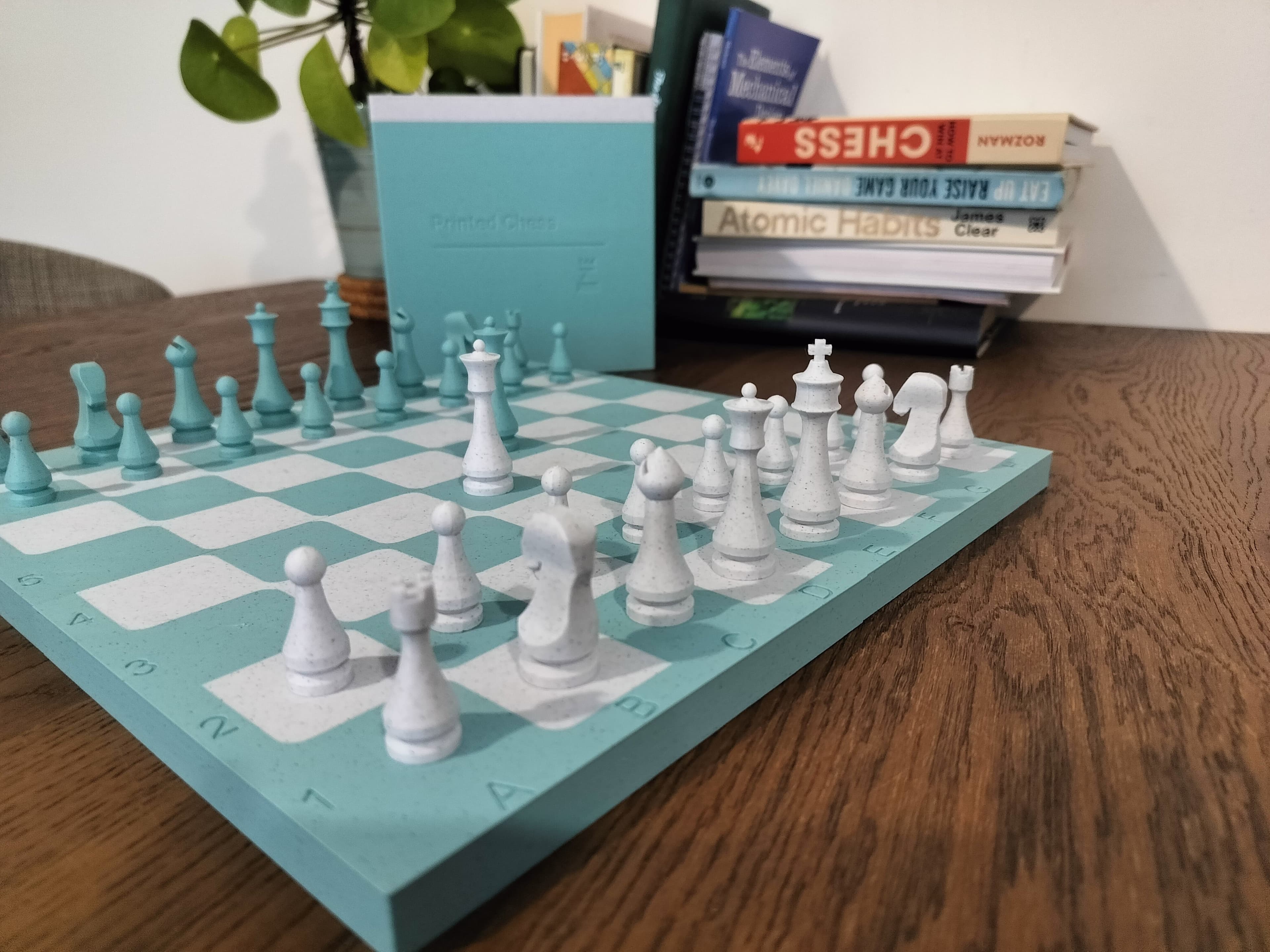 Teal and white Printed Chess board on a desk