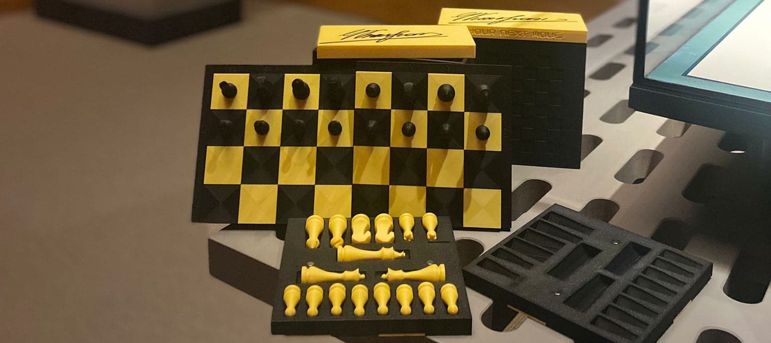 Custom black and gold chessboard and box prepared for the Your Next Move tournament